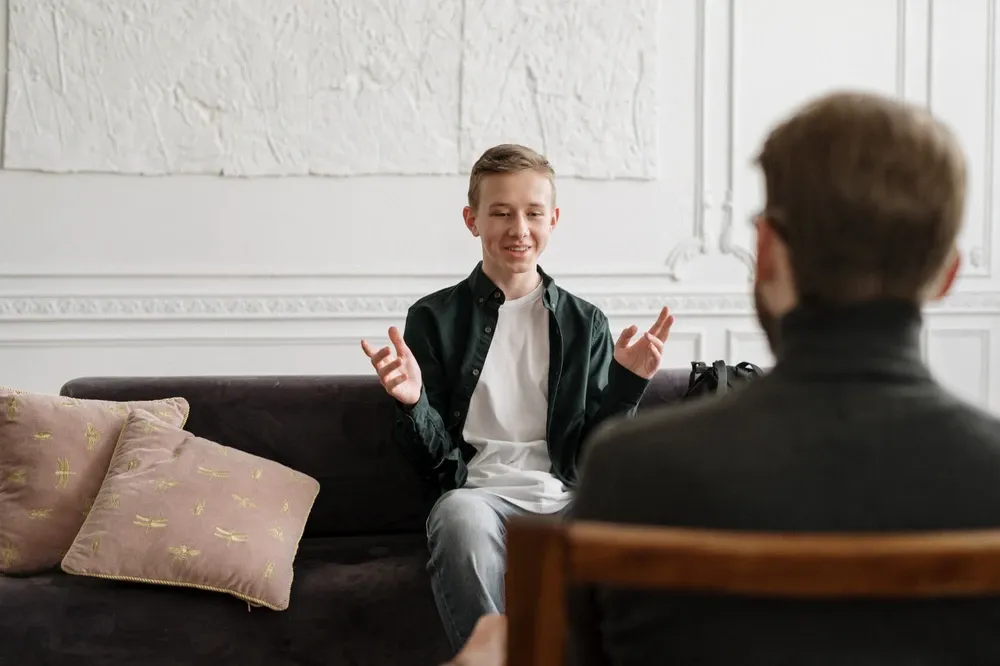 teenager in therapist's office